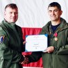 Rear Admiral Christopher Sweeney bestows the Legion of Merit Award to Capt. Todd Cimicata.